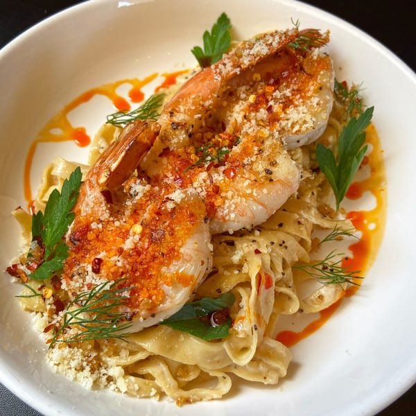Picone's Italian shrimp scampi with fettuccine pasta, red pepper flakes, and fresh herbs.